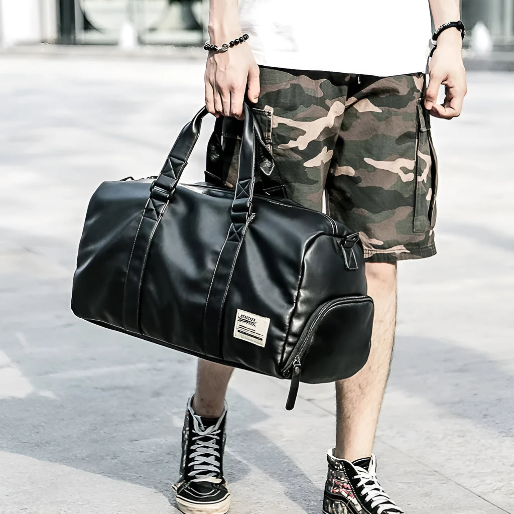 Black waterproof PU leather large capacity sports training bag showing internal computer and camera pockets