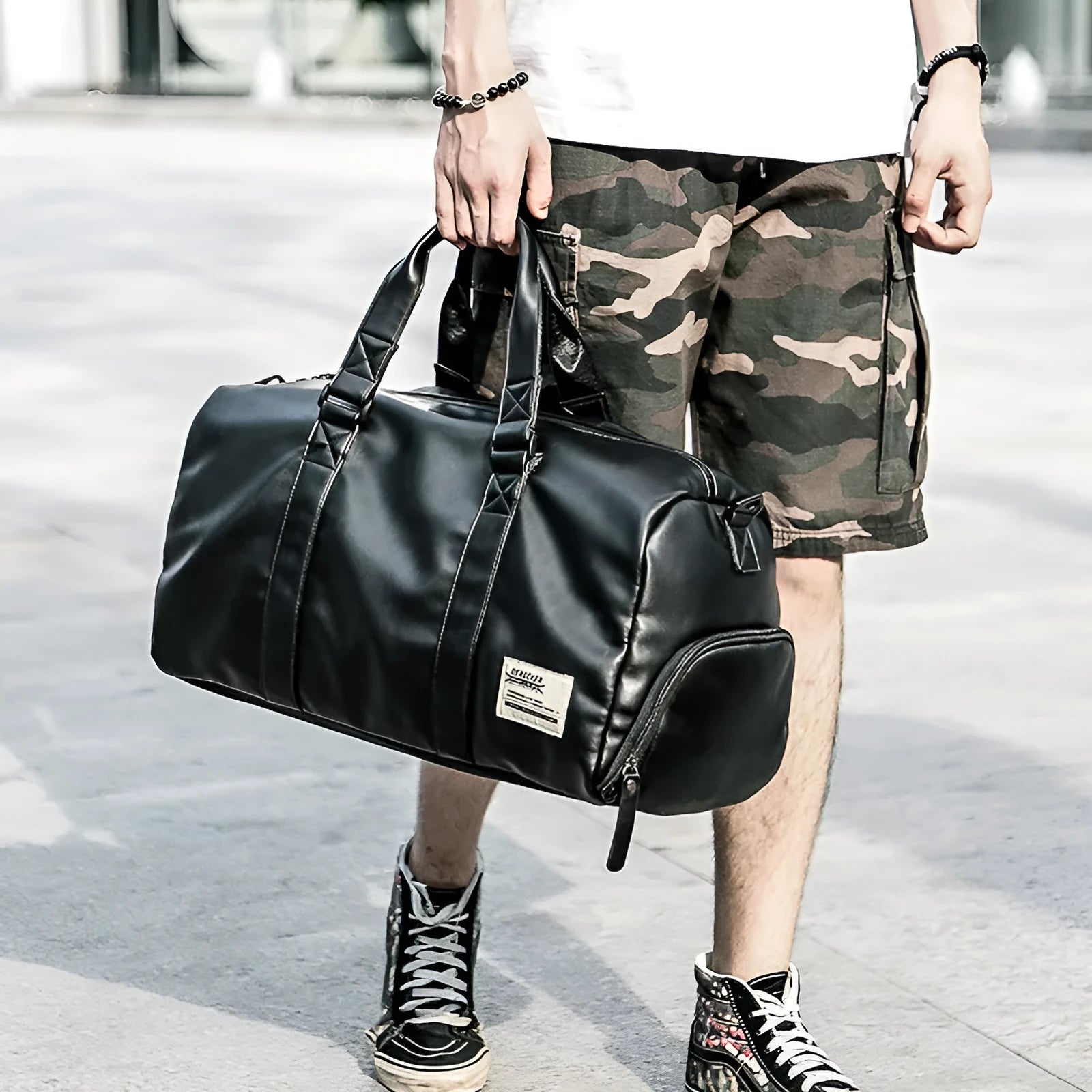Black waterproof PU leather large capacity sports training bag showing internal computer and camera pockets