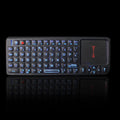 Black wireless mini keyboard with integrated touch screen and laser pointer for teaching presentations.