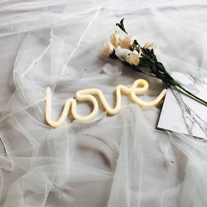 Pink LED neon sign light with silicone shell, powered by battery or USB for wedding table decorations.