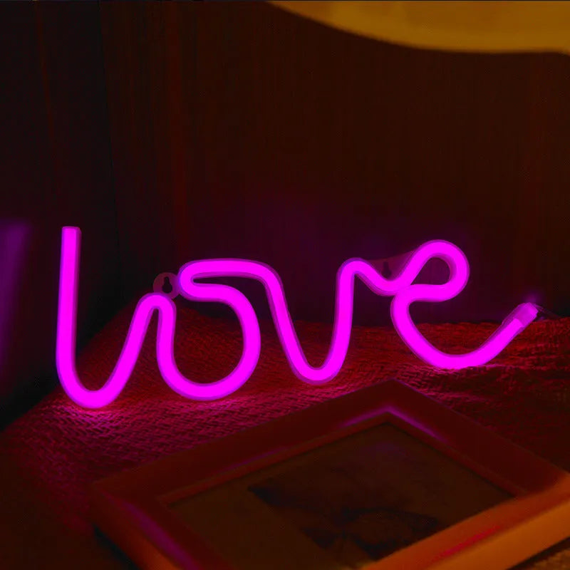 Pink LED neon sign light with silicone shell, powered by battery or USB for wedding table decorations.