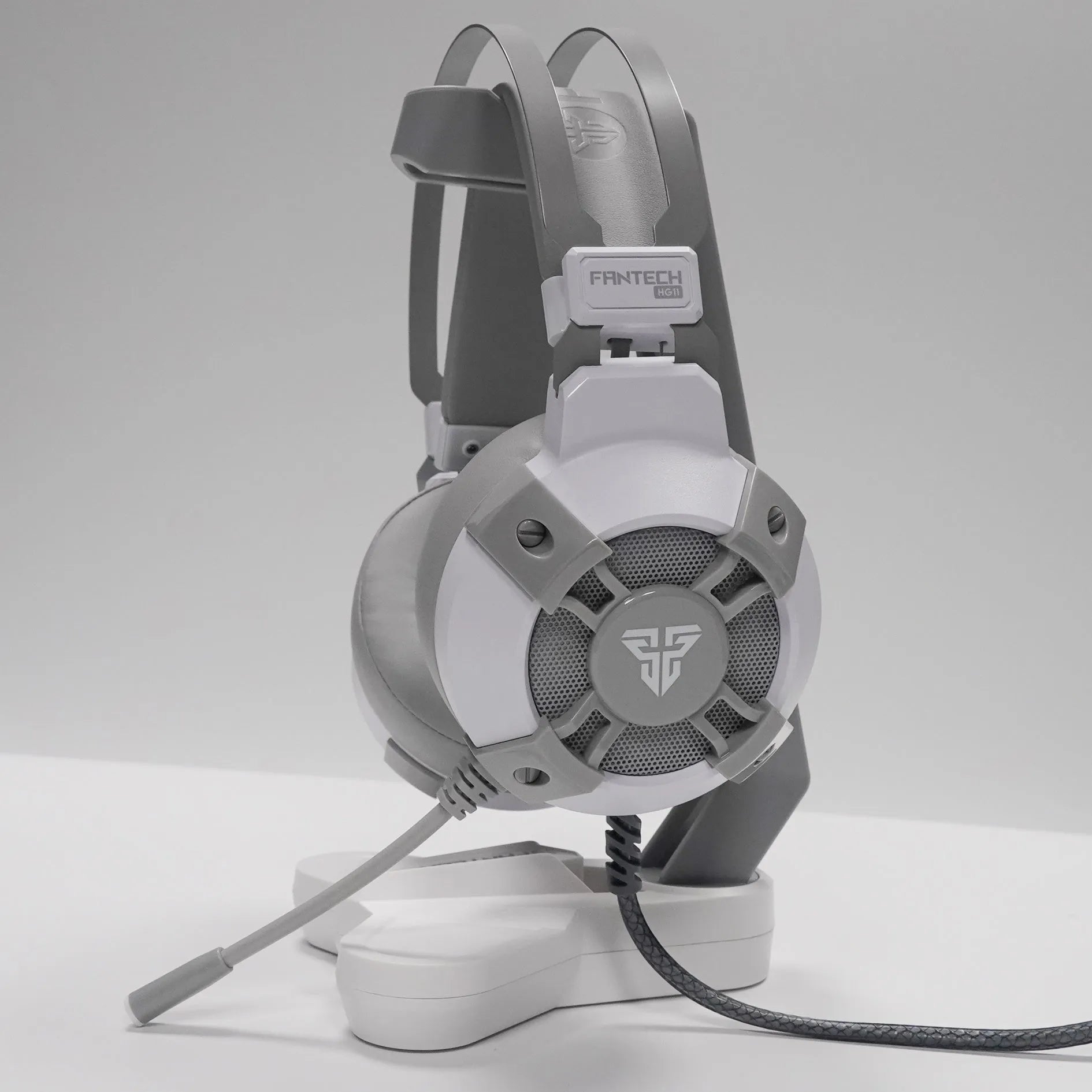 Black FANTECH HG11 USB gaming headset with large earcups, an adjustable microphone, and RGB lighting on the sides.
