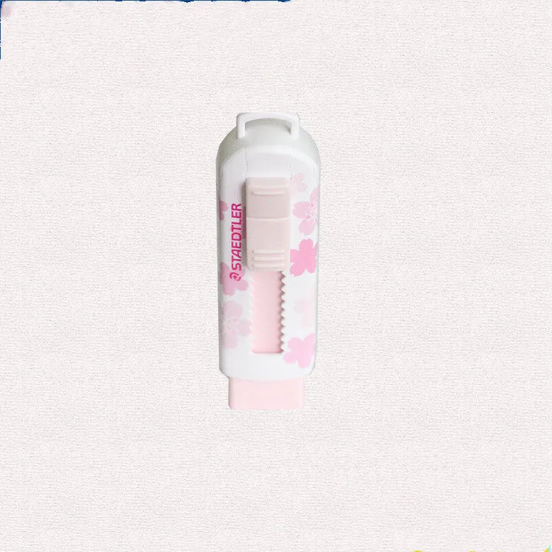 Square pink push-pull rubber eraser with replaceable core, shown next to a pencil for scale.