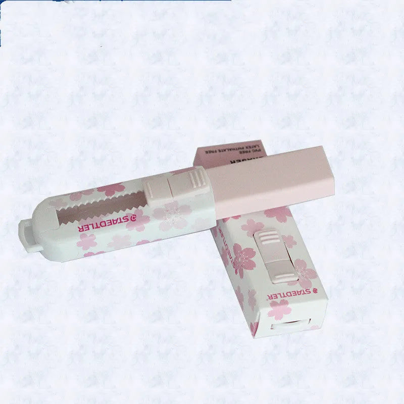 Square pink push-pull rubber eraser with replaceable core, shown next to a pencil for scale.