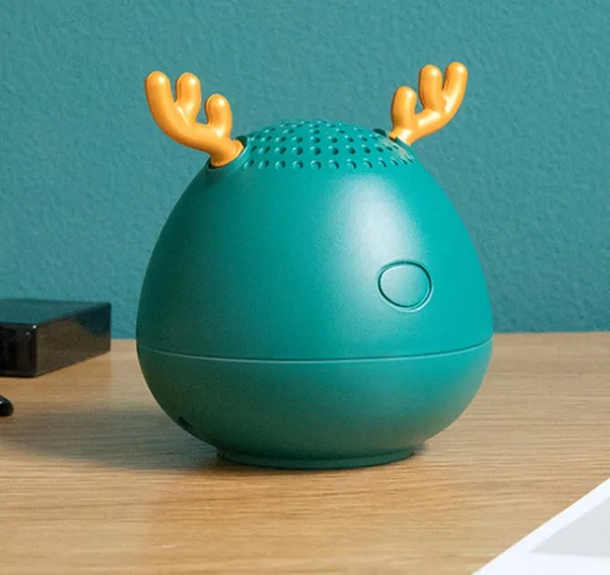 Compact Bluetooth wireless speaker in green colour with USB charging cable