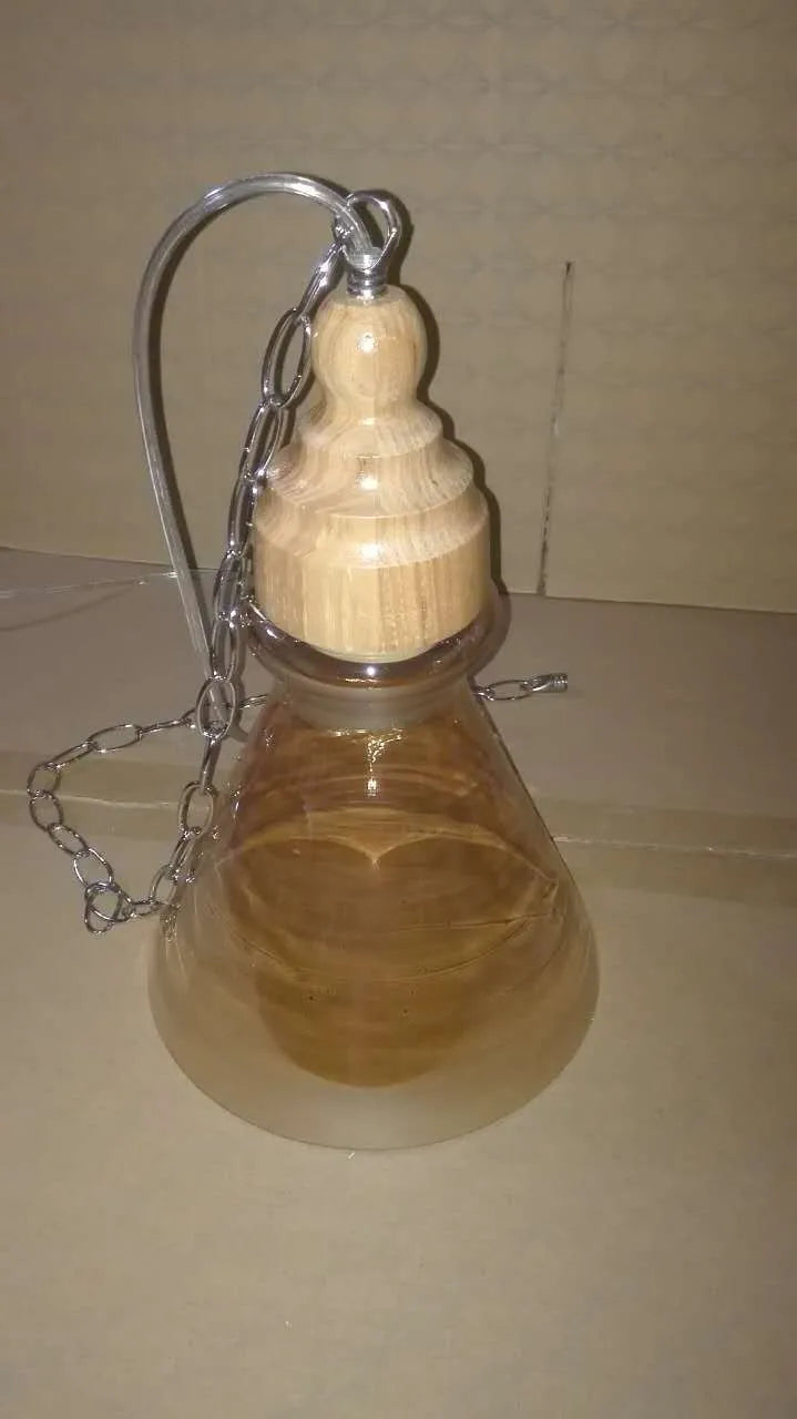Glass single head pendant light with wood grain finish and adjustable height mechanism