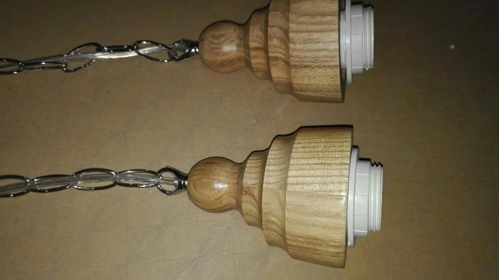 Glass single head pendant light with wood grain finish and adjustable height mechanism