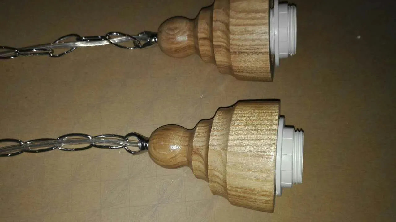 Glass single head pendant light with wood grain finish and adjustable height mechanism