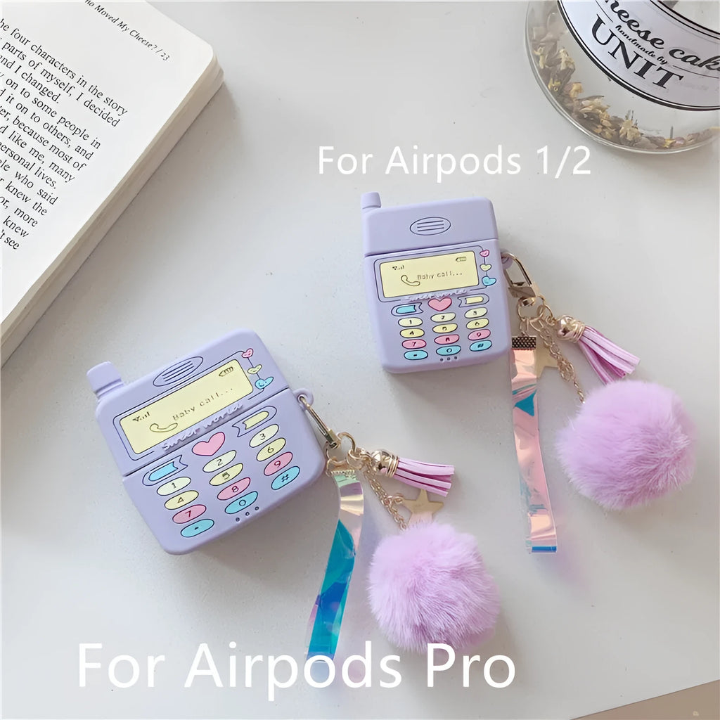 Purple silicone clamshell case for Apple AirPods with a small fur ball pendant attached.