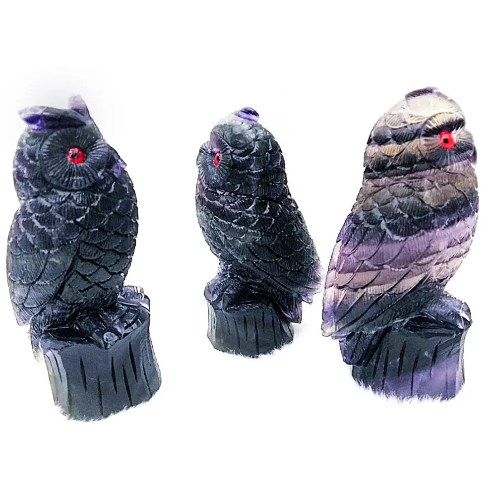 Purple fluorite hand-carved night owl ornament on display surface showing detailed carving