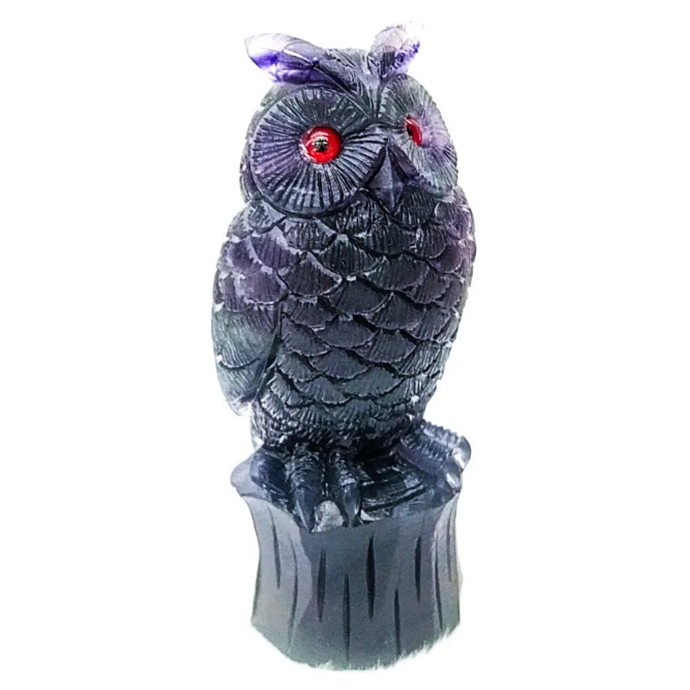 Purple fluorite hand-carved night owl ornament on display surface showing detailed carving