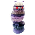 Purple fluorite hand-carved night owl ornament on display surface showing detailed carving