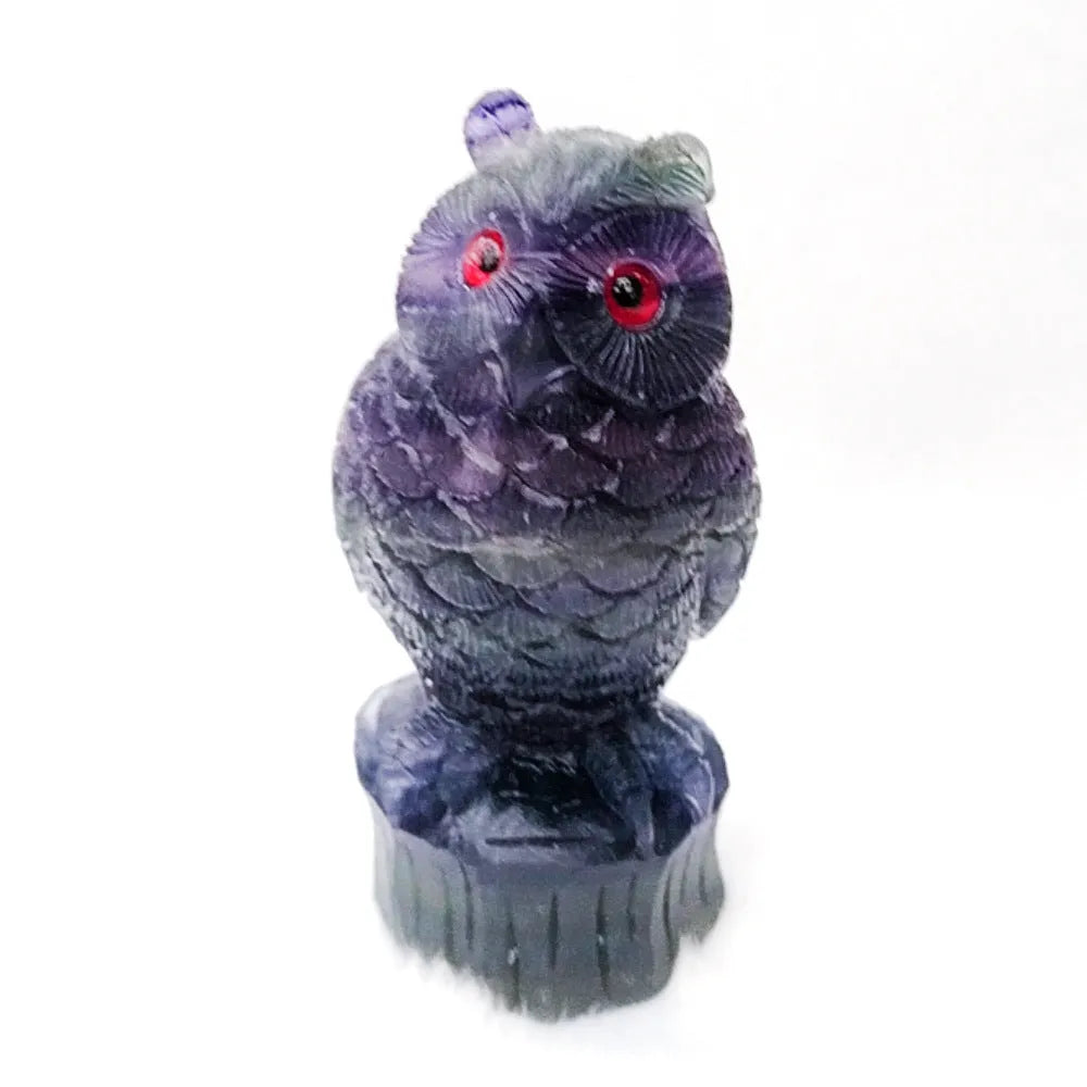 Purple fluorite hand-carved night owl ornament on display surface showing detailed carving