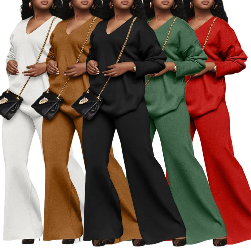 Women's brown suede two-piece suit with split sleeve top and matching trousers laid flat