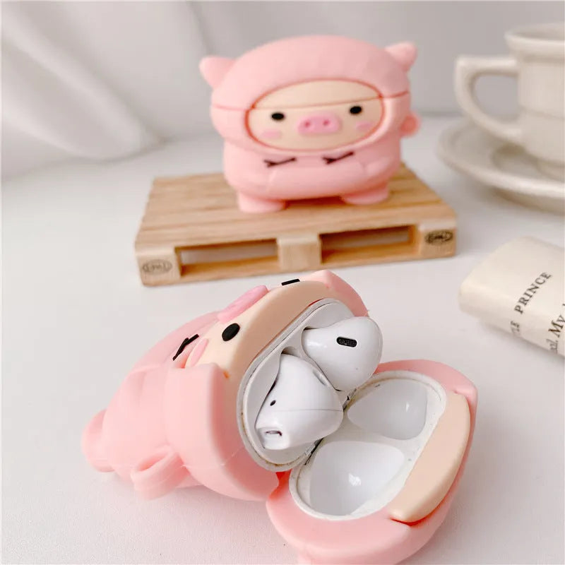 Pink silicone flip case for AirPods with cartoon pig design and a metal hook.