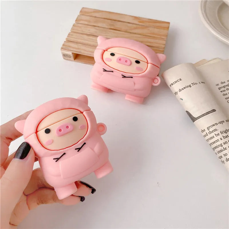 Pink silicone flip case for AirPods with cartoon pig design and a metal hook.