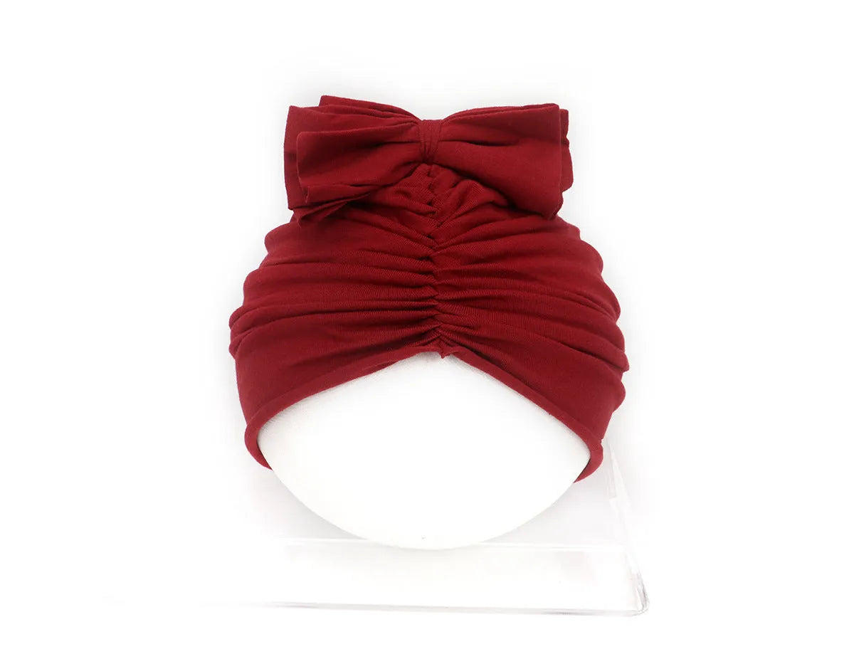 Soft knitted acrylic baby girl hat in turban style for infants 0-28 months in various candy colours