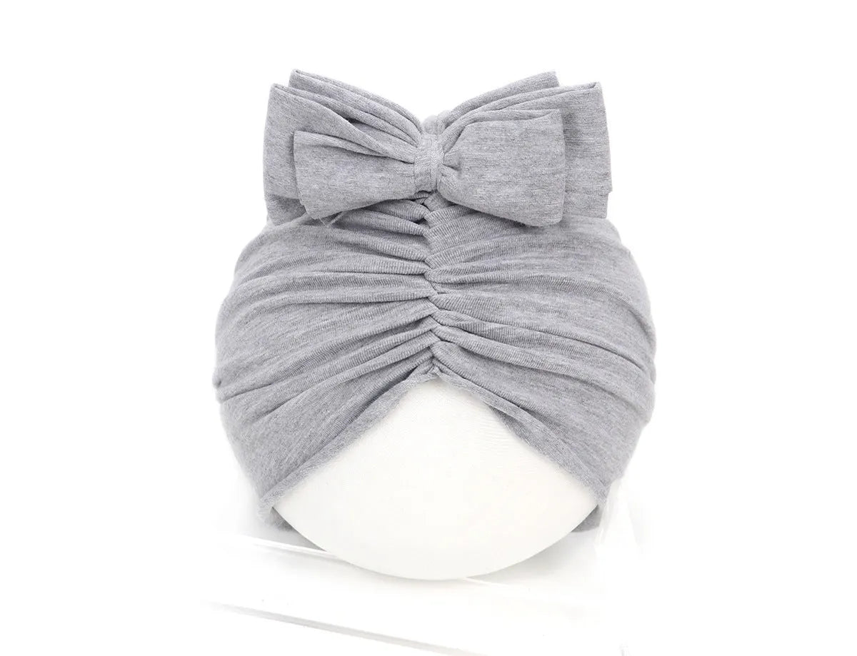 Soft knitted acrylic baby girl hat in turban style for infants 0-28 months in various candy colours
