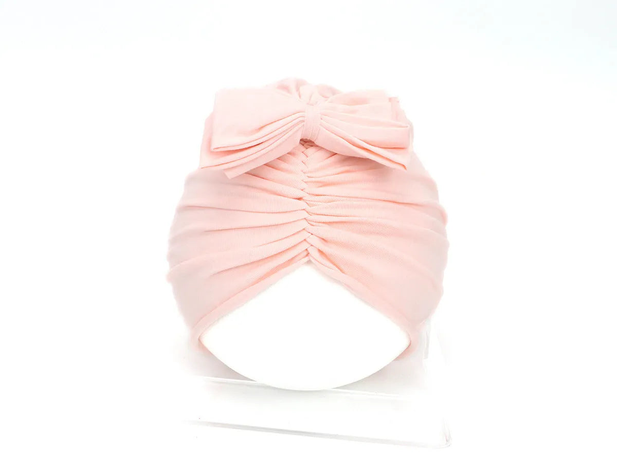 Soft knitted acrylic baby girl hat in turban style for infants 0-28 months in various candy colours