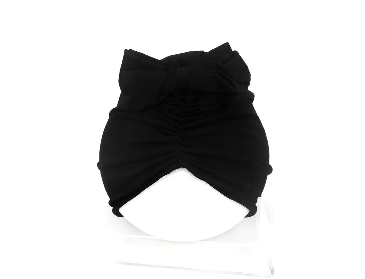 Soft knitted acrylic baby girl hat in turban style for infants 0-28 months in various candy colours