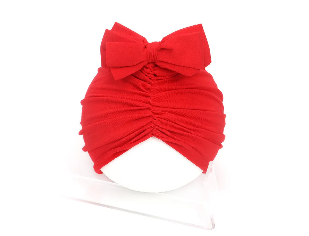 Soft knitted acrylic baby girl hat in turban style for infants 0-28 months in various candy colours