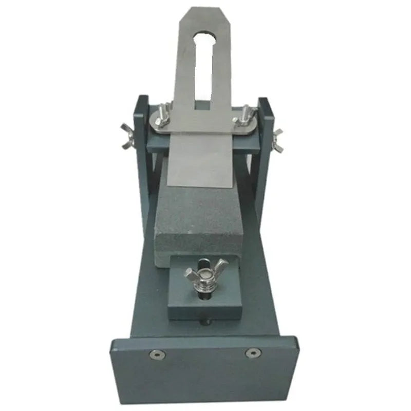Fixed angle sharpening tool for woodworking planers and chisels on a workbench.