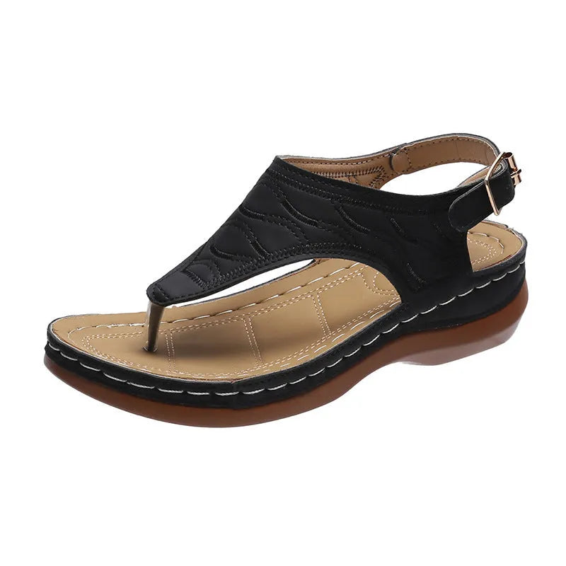Women's wedge heel flip flop sandals with an adjustable back buckle strap in black.