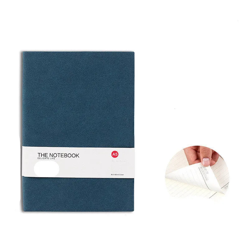 Green, dark blue, and orange red solid colour thickened A5 and B5 notebooks laid flat.