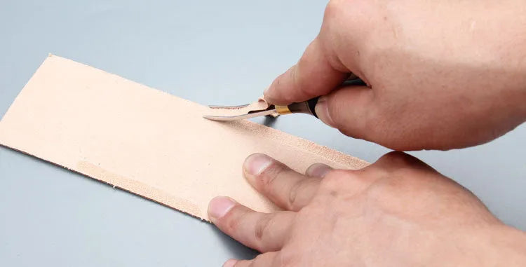 Sectional wide shovel edge thinning knife with leather handle for tool maintenance.