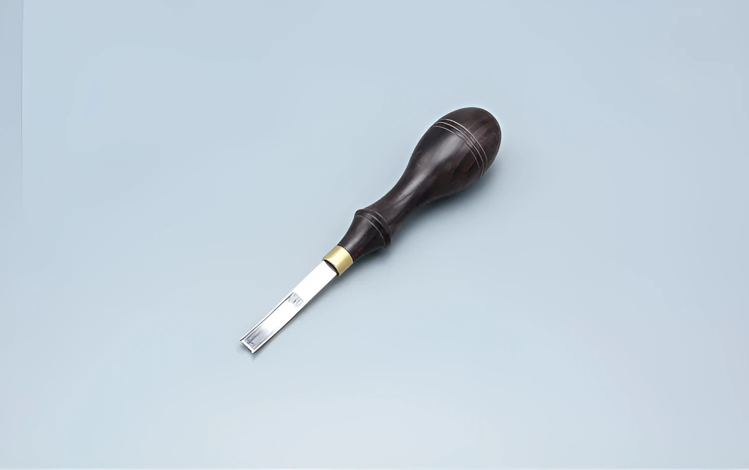 Sectional wide shovel edge thinning knife with leather handle for tool maintenance.