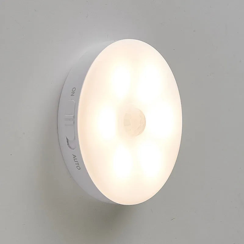 Wireless motion sensor LED night light with magnetic charging base for automatic illumination