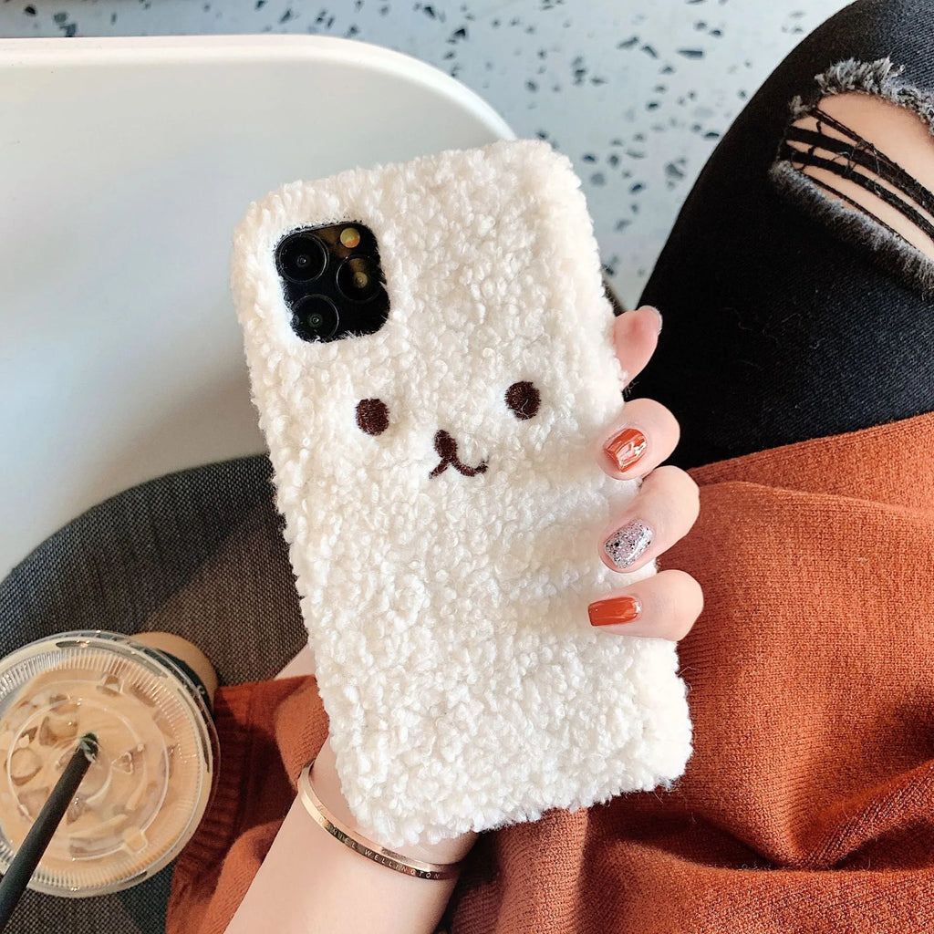 Brown embroidered plush cartoon bear face on a flexible TPU iPhone case.
