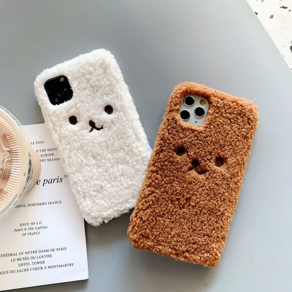 Brown embroidered plush cartoon bear face on a flexible TPU iPhone case.
