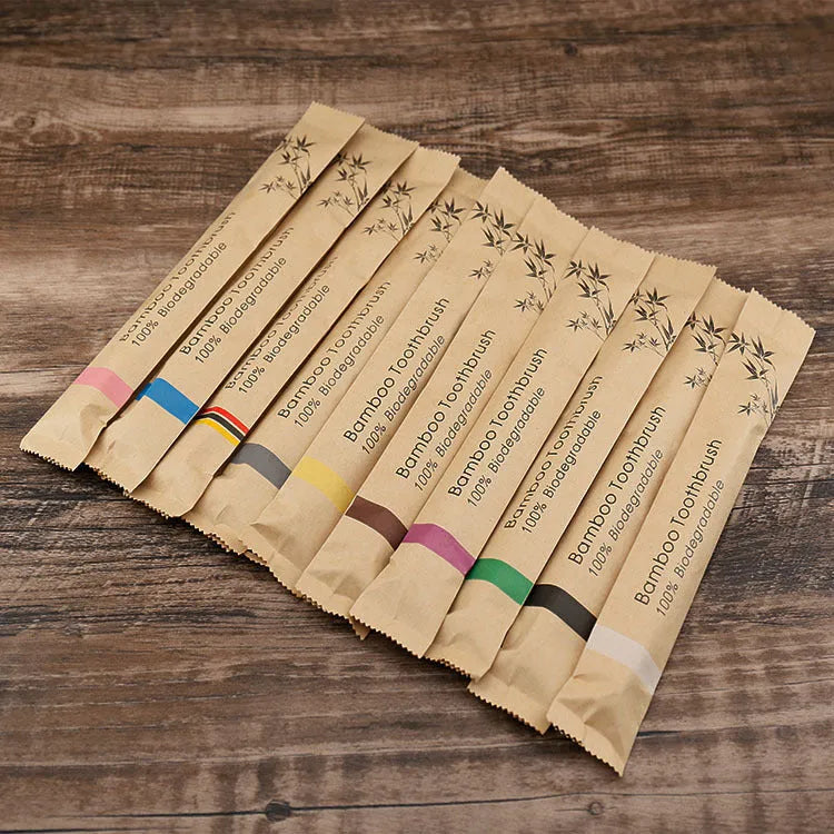 Set of 10 natural bamboo toothbrushes with charcoal bristles in various colours on white background