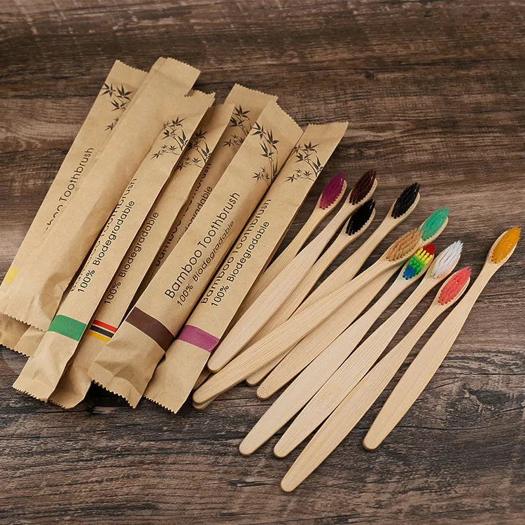 Set of 10 natural bamboo toothbrushes with charcoal bristles in various colours on white background
