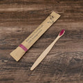 Set of 10 natural bamboo toothbrushes with charcoal bristles in various colours on white background