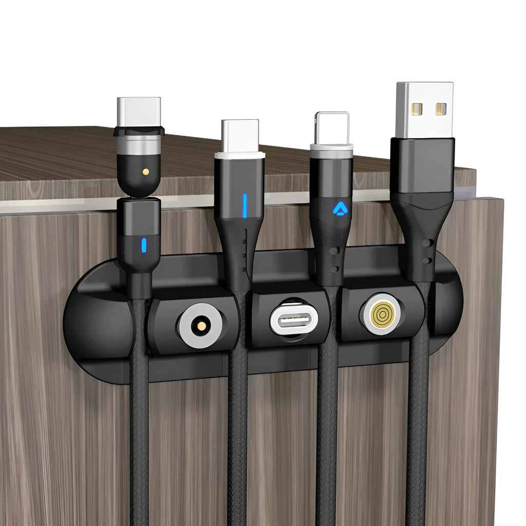 Black soft plastic magnetic desktop charging cable organiser stand on a desk.