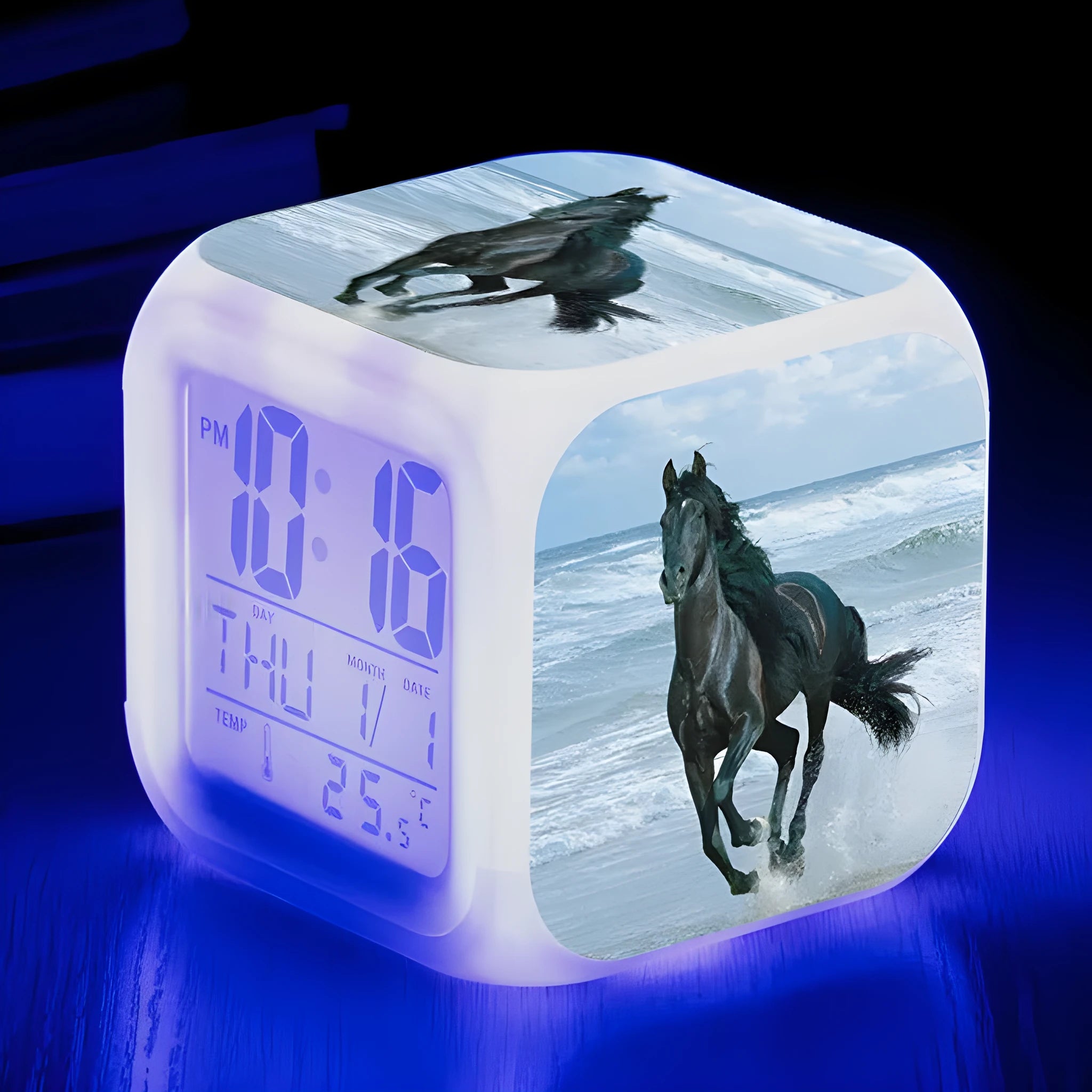 Square cartoon-style LED alarm clock with colour-changing display showing digital time and temperature