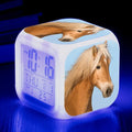 Square cartoon-style LED alarm clock with colour-changing display showing digital time and temperature