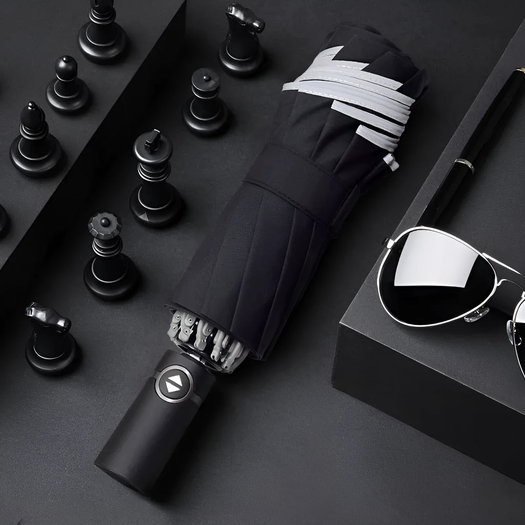 Black automatic reverse umbrella showing three-fold design with non-slip plastic handle