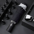 Black automatic reverse umbrella showing three-fold design with non-slip plastic handle
