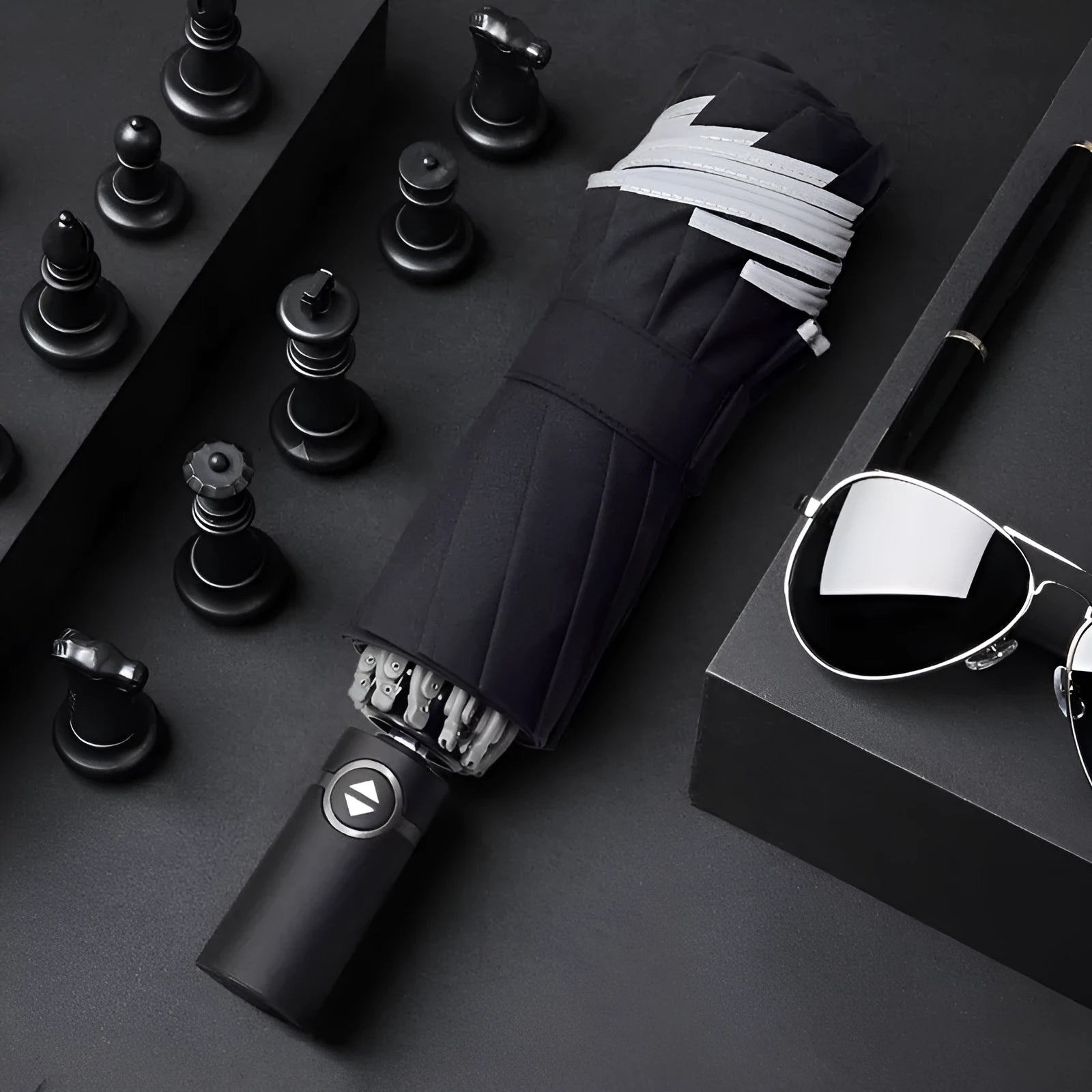 Black automatic reverse umbrella showing three-fold design with non-slip plastic handle