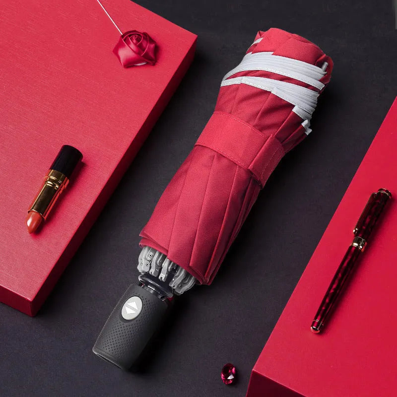 Black automatic reverse umbrella showing three-fold design with non-slip plastic handle