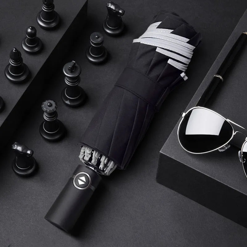 Black automatic reverse umbrella showing three-fold design with non-slip plastic handle
