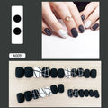 Fake nail patch with matte black and white lines design on a white background