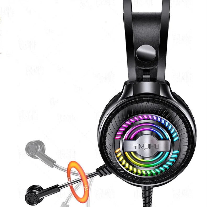 Black wired over-ear computer headset with microphone and 3.5mm plug on a desk.