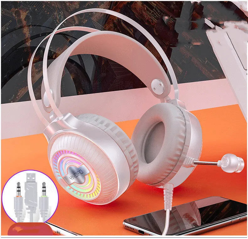 Black wired over-ear computer headset with microphone and 3.5mm plug on a desk.