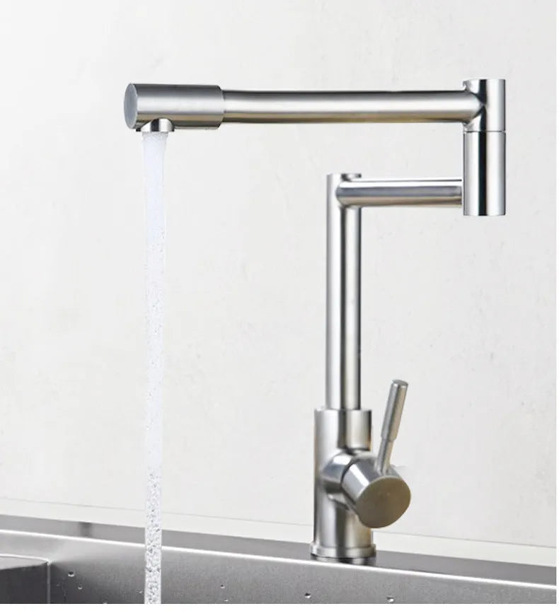 Silver stainless steel kitchen tap with dual rotating spouts for hot and cold water