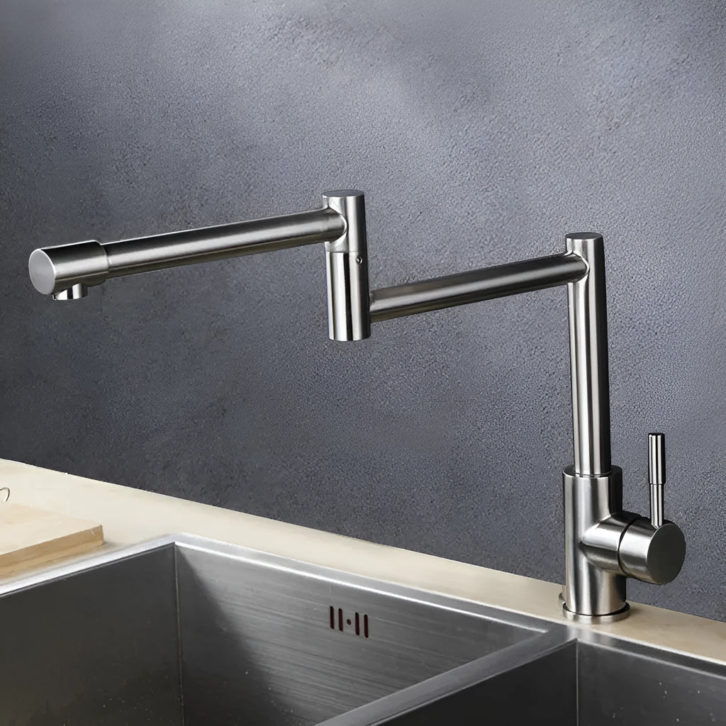 Silver stainless steel kitchen tap with dual rotating spouts for hot and cold water