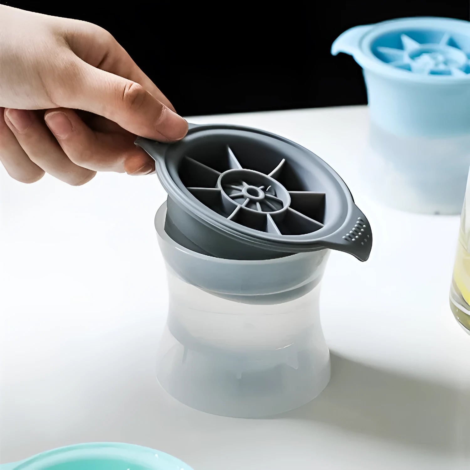 Silicone ice tray producing large ice hockey artefacts and geometric ice cubes in multiple colour variations